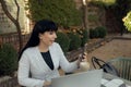 Confident businesswoman wearing casual clothes and using a laptop while working online. Online work concept Royalty Free Stock Photo