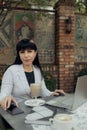 Confident businesswoman wearing casual clothes and using a laptop while working online. Online work concept Royalty Free Stock Photo