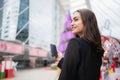 Confident businesswoman wearing suit standing in city with building background. Using mobile phone outdoors. Technology and Royalty Free Stock Photo