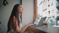 Confident businesswoman working laptop at cafe close up. Asian woman drinking Royalty Free Stock Photo