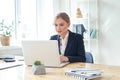 Confident businesswoman working on laptop at her workplace at modern office Royalty Free Stock Photo