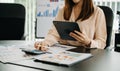 Confident businesswoman working on laptop,tablet and tablet at her workplace at office Royalty Free Stock Photo