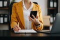 Confident businesswoman working on laptop,tablet and smartphone at her workplace at office Royalty Free Stock Photo