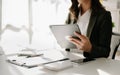 Confident businesswoman working on laptop,tablet and tablet at her workplace at office Royalty Free Stock Photo