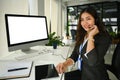 Confident call center or telemarketing operator woman working in office with headset and computer. Customer care support Royalty Free Stock Photo