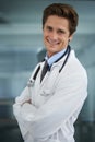 Confident he can help you. Portrait of a handsome young doctor with a stethoscope around his neck smiling at the camera. Royalty Free Stock Photo