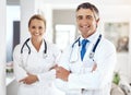 Confident we can take care of you. Cropped portrait of two doctors standing with their arms crossed in the hospital Royalty Free Stock Photo