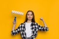 Confident Young Woman Is Holding Paint Roller