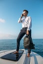 Handsome male model posing in front of a luxury yacht during summer vacation Royalty Free Stock Photo