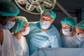 Confident caucasian doctors and assistants take childbirth