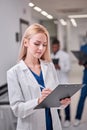 Confident Caucasian Female Doctor In White medical Unifrom with clipboard in hospital Royalty Free Stock Photo