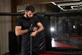 Confident Caucasian Male Kickboxer Fighter Preparing For Fight, Wrapping Hand In Bandage