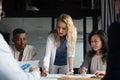 Confident businesswoman lead meeting with diverse colleagues in office Royalty Free Stock Photo