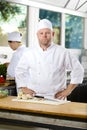 Confident chef standing in large kitchen Royalty Free Stock Photo