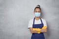Confident cleaning lady wearing rubber gloves and medical protective face mask keeping arms crossed, looking at camera Royalty Free Stock Photo