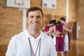 Confident coach standing in basketball court