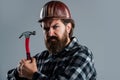 Confident construction engineer. professional architect. repair and building. use hammer tool. serious male worker wear Royalty Free Stock Photo