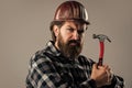 confident construction engineer. professional architect. repair and building. use hammer tool. serious male worker wear Royalty Free Stock Photo