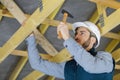 confident construction worker hammering nail on wooden plank Royalty Free Stock Photo