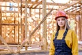 confident constructor engineer female in New residential construction home framing