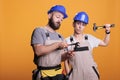 Confident constructors holding renovating tools Royalty Free Stock Photo