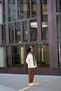 Confident cool young African American guy standing big city at modern street. Royalty Free Stock Photo