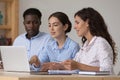 Confident corporate teacher training interns, sharing laptop Royalty Free Stock Photo