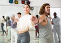 Confident couple of dancers enjoys a partner dance