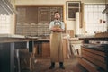 Confident craftsman standing in his workshop studio