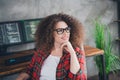 Confident curly-haired programmer in a cozy workspace, working on coding projects while thinking creatively and solving Royalty Free Stock Photo