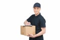 Confident deliveryman at work. Cheerful young deliveryman holding a cardboard box with a clipboard on it and smiling while