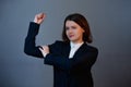 Confident and determined businesswoman flexing muscles showing her strength, positive face expression. Personal development and