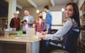 Confident disabled businesswoman writing at desk Royalty Free Stock Photo