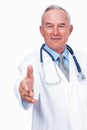 Confident doctor extending handshake. Portrait of smiling mature doctor with stethoscope extending hand to shake. Royalty Free Stock Photo