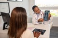 Confident doctor showing x-ray picture of lungs to patient Royalty Free Stock Photo