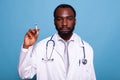 Confident doctor in white lab coat holding syringe with hypodermic needle Royalty Free Stock Photo