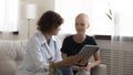 Physician explain treatment to female sick with cancer using tablet Royalty Free Stock Photo