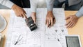 Confident engineer team working with Blue Print with architect equipment discussing and Planning work flow construction project. w Royalty Free Stock Photo