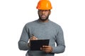 Confident engineer writing on clipboard. Royalty Free Stock Photo