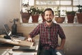 Confident entrepreneur designer sitting in his office space