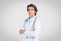 Confident european male doctor with arms crossed smiling Royalty Free Stock Photo