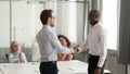 Confident executive shaking hand of successful African American employee Royalty Free Stock Photo