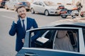 Confident executive talking on phone next to limousine Royalty Free Stock Photo