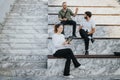 Confident executives analyze project details outdoors, reviewing paperwork and strategizing for profitability Royalty Free Stock Photo