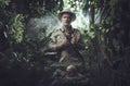 Explorer with binoculars in the jungle Royalty Free Stock Photo