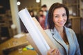 Confident female architect with blueprints in office Royalty Free Stock Photo