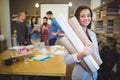 Confident female architect with blueprints Royalty Free Stock Photo