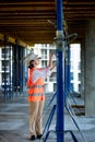 Confident Female builder checks fastenings on a monolithic structure. Construction concept Royalty Free Stock Photo