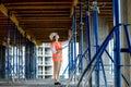 Confident Female builder checks fastenings on a monolithic structure. Construction concept Royalty Free Stock Photo