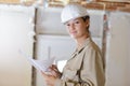 confident female builder standing with clipboard Royalty Free Stock Photo
